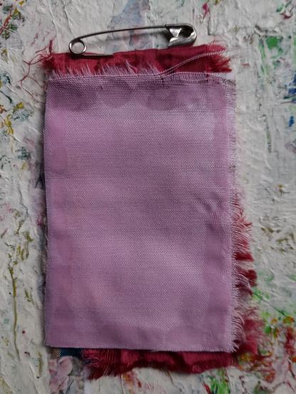 The backside is bright pink satin.