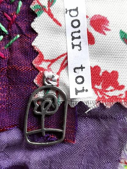 Detail of the connection between paper and fabrics - and the small flower cage. The words: pour toi - for you.