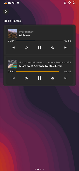 A screenshot of a smart phone running phosh. The phone is locked and shows the lock lockscreen plugins page. The currently selected plugin shows two media player widgets tracking running media players on the system via mpris: one for podcasts (a podcast player) and one for gapless (a music player)