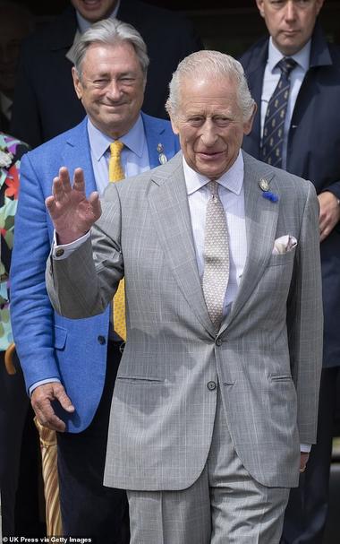King Charles (pictured, centre) appeared to be enjoying his day out at the Royal Windsor Flower Show on Saturday (seen with Alan Titchmarsh)