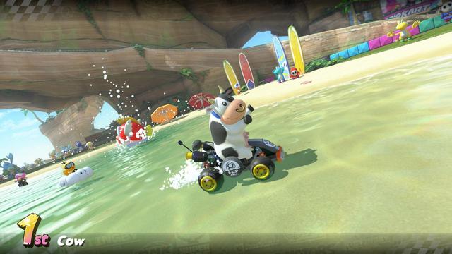 Cow in Mario Kart end of race summary showing first position. Other carts are in the background along with some surfboards