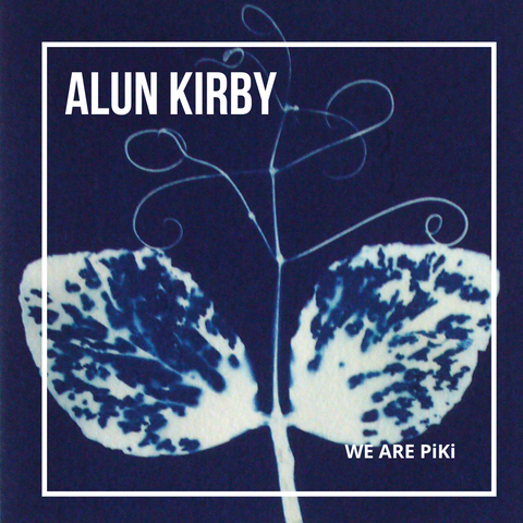 A cyanotype image of a sweet pea plant that is two leaves either side of a stem, with curly tendrils coming out of the top.
It is white on a blue background, with an overlay of a thin white frame and the name Alun Kirby