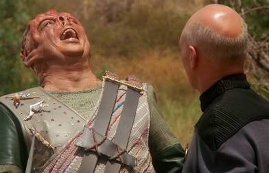 Dathon with a hearty laugh as Picard looks on
