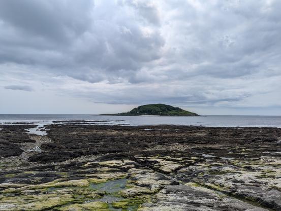 Small island seen across a rocky beach