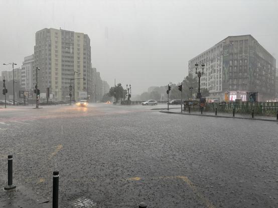 Incredibly wet view of Bucharest from a damp bus stop.