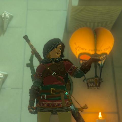 Link from ToTK holding his hand out with a big hot air balloon in background, it looks like a giant butt