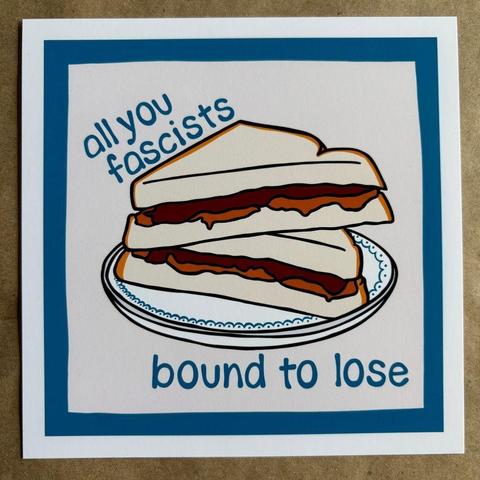 Original art by AnneArchy of a peanut butter and jelly sandwich on a classic plate with hand lettering of the words "all you fascists bound to lose".