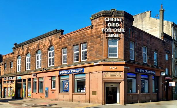 A low, two-storey, red sandstone nank building in Glasgow.
