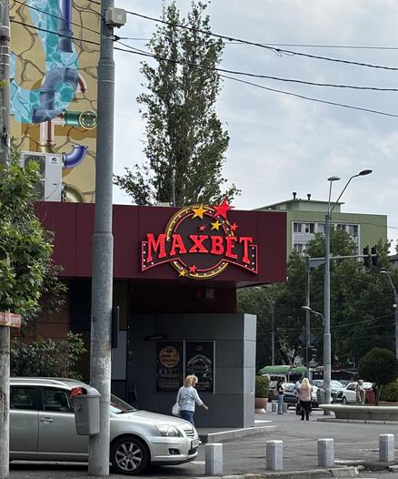 Bright flashing sign reading "Maxbet".