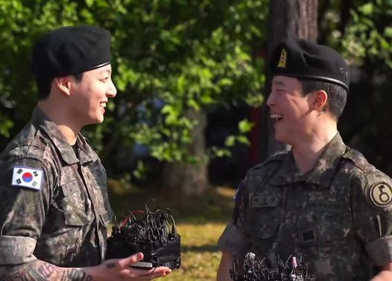 Jungkook and Jimin of BTS sharing a laugh during their  military discharge ceremony.