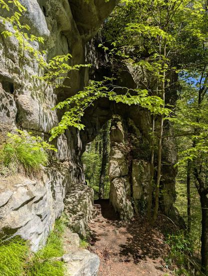 The trail heads through an arch made of sandstone.