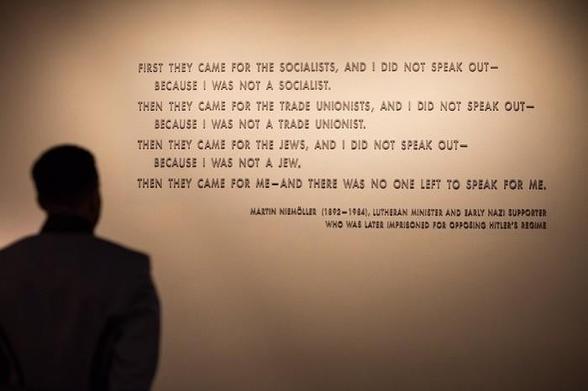 Screen shot of a person reading a poem with a short statement about the author of the poem on the wall of the Holocaust Museum:

First they came for the Socialists, and I did not speak out
Because I was not a Socialist.

Then they came for the trade unionists, and I did not speak out
Because I was not a trade unionist.

Then they came for the Jews, and I did not speak out
Because I was not a Jew.

Then they came for me, and there was no one left
To speak out for me.

Martin Niemöller (1892-1984), Lutheran minister and early Nazi supporter, who was later imprisoned for opposing Hitler’s regime.