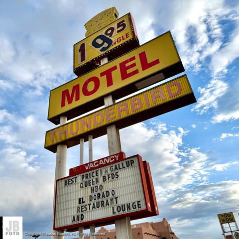 A relatively modern designed signage for a motel in Gallup, New Mexico. The majority of the sign is in yellow color. It says “19.95 Single. Motel. Thunderbird. Best Price in Gallup. Queen BFDS. HBO. El Dorado Restaurant. And Lounge”.