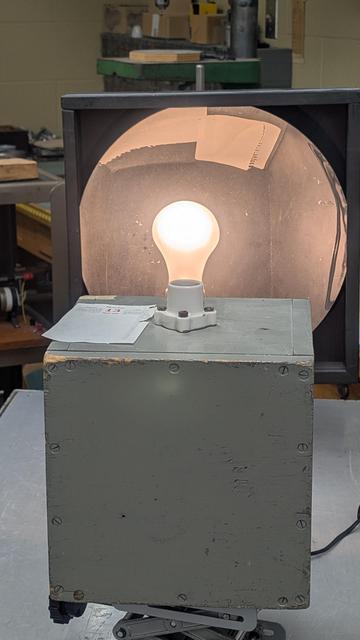 Real image of a lightbulb which looks like a lightbulb sitting upright in a socket.