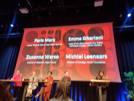 Picture of the PublicSpaces main stage with the names of 4 panel members