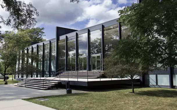 The image depicts a modern building with a glass facade and a series of steps leading up to its entrance. It is surrounded by trees and grassy areas, suggesting it is set in a landscaped environment. The design appears contemporary, characterized by clean lines and a minimalist aesthetic.

Image Credits: Wikimedia / Arturo Duarte Jr. / CC BY-SA 3.0