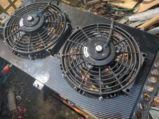 A fan shroud for my rear mounted radiator, with two 10" fans mounted into it. The shroud will attach to the back of the radiator to ensure that the fans only suck air through the radiator rather than from everywhere around it; it makes it more efficient.