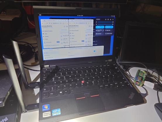 a ThinkPad with 3 wifi connections, two for two rnodes running meshchat. The usb wifi dongles are sticking up on the left