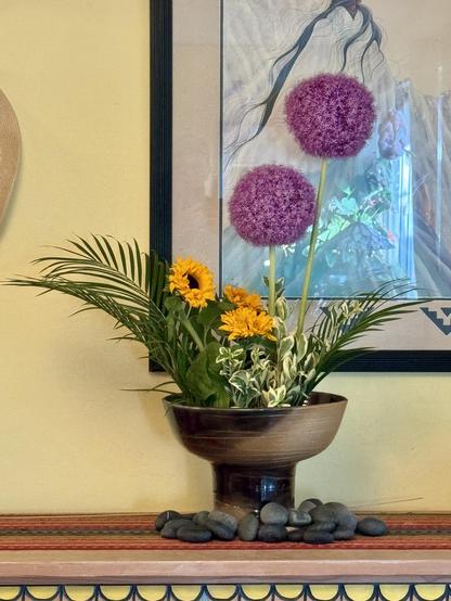 Moribana style arrangement either giant purple allium, sunflowers, and palm fronds.