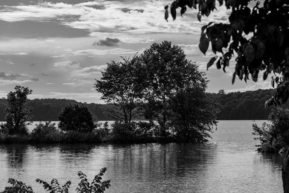 Photograph of a lake after a rain storm with the sky starting to look a little less angry.