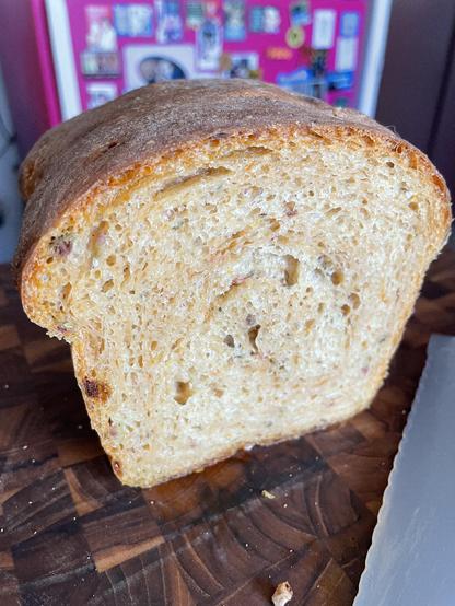 Closeup of sandwich loaf shaped bread cut open to show golden brown interior.