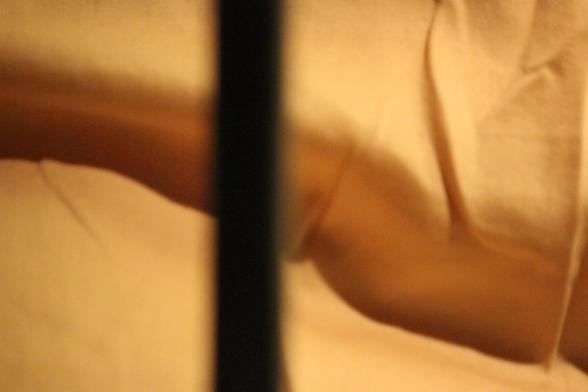 Yellow-toned image of wavy fabric interrupted by a vertical line tilt.