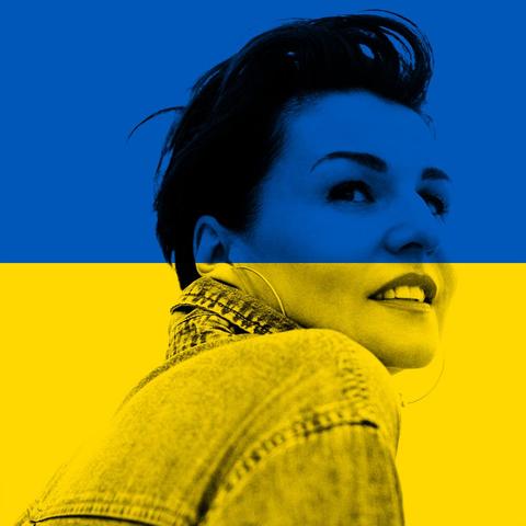 Alina Bzhezhinska in a denim jacket gazes upwards with a hopeful expression, overlaid with the blue and yellow colors of the Ukrainian flag.