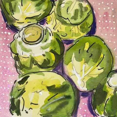 Six Brussels sprouts on a pink surface