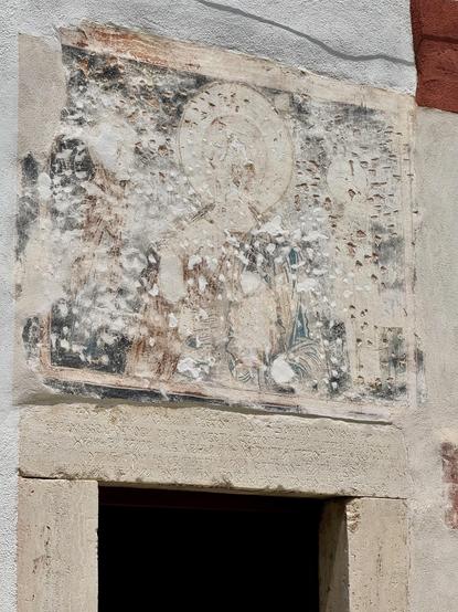 Fresco that has been systematically chiselled; some holes have subsequently been filled