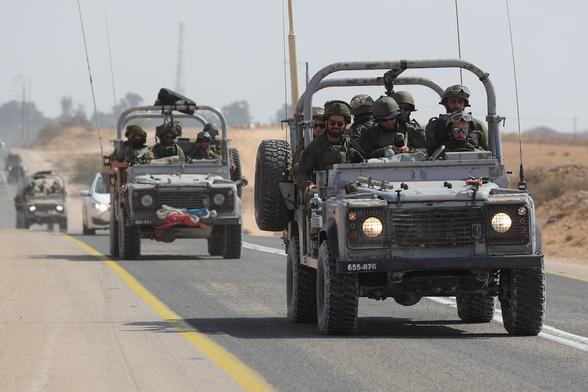 Israeli soldiers drive along the border with Gaza near the southern city of Ofakim, October 11, 2023.