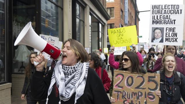 Community organizer Emerson Wolfe leads a march hosted by Indivisible Greater Grand Rapids down Ottawa Avenue during a Hands Off! rally, April 5, 2025, in Grand Rapids, Mich. (Arthur H. Trickett-Wile/The Grand Rapids Press via AP)