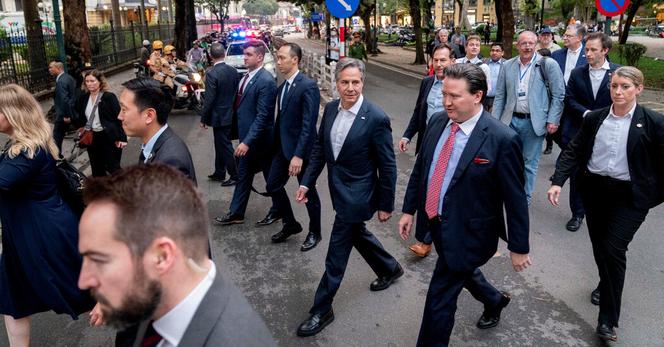 U.S. Secretary of State Antony Blinken, center, accompanied by the U.S. ambassador to Vietnam, Marc Knapper, in red tie, walking to Binh Minh Jazz Club in Hanoi, Vietnam, in April 2023.
