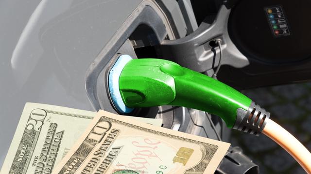 An electric car and dollar bills