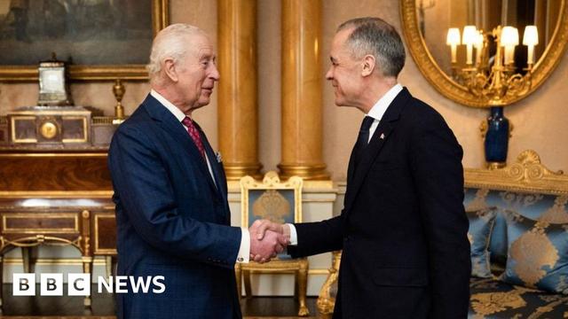 Britain's King Charles III (L) shakes hands as he welcomes Canada's Prime Minister Mark Carney ahead of an audience at Buckingham Palace, in central London, on March 17, 2025.