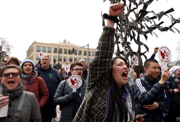 A graduate student at Northeastern University cheers as Congresswoman Ayanna Pressley (not pictured) speaks to a crowd gathered in support of Boston University graduate worker students striking for fair pay, better health care coverage and stronger benefits, in Boston, Massachusetts, on March 26, 2024.