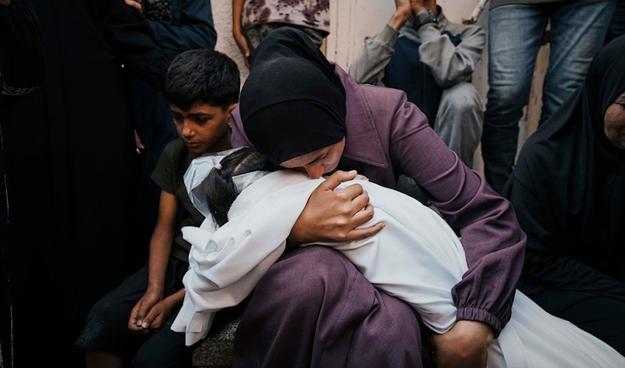 A Palestinian woman mourns as she embraces the body of her daughter Mayar Abu Odeh, 8, who was killed in an Israeli army strike on Gaza. at Al-Shifa Hospital in Gaza City, Wednesday, June 4, 2025. (AP)