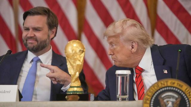 President Donald Trump gestures past Vice President JD Vance during a FIFA task force meeting on the 2026 FIFA World Cup in the East Room of the White House, Tuesday, May 6, 2025, in Washington. (AP Photo/Mark Schiefelbein)