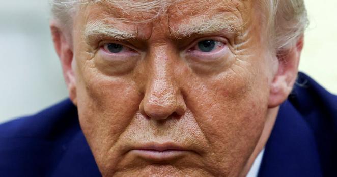 FILE PHOTO: U.S. President Donald Trump looks on as he meets South African President Cyril Ramaphosa in the Oval Office of the White House in Washington, D.C., U.S., May 21, 2025. REUTERS/Kevin Lamarque/File Photo