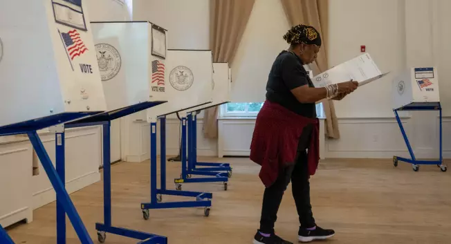 A woman casts her ballot at her poll site.