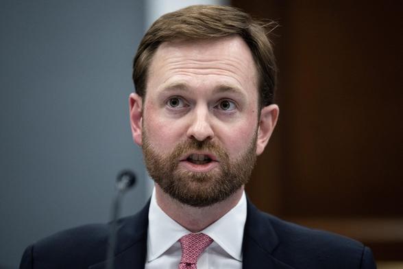 FTC Chairman Andrew Ferguson speaking into a microphone while sitting at a table. FTC Chairman Andrew Ferguson speaking into a microphone while sitting at a table.