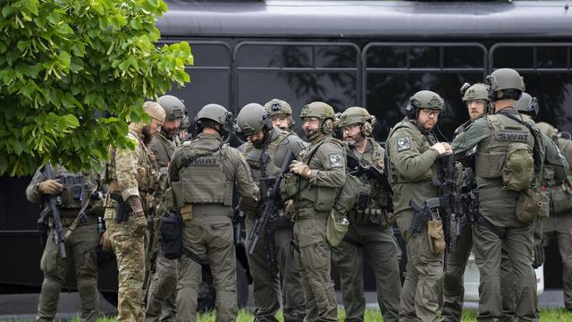Law enforcement officers including local police, sheriffs and the FBI, stage less than a mile from a shooting in Brooklyn Park, Minn. on Saturday, June 14, 2025. (Alex Kormann/Star Tribune via AP)