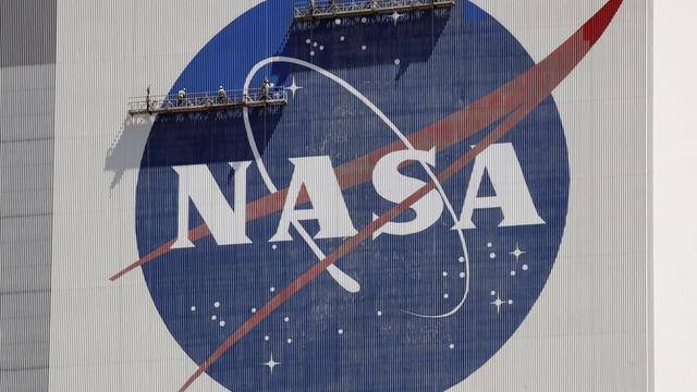 Workers on scaffolding repaint the NASA logo near the top of the Vehicle Assembly Building at the Kennedy Space Center in Cape Canaveral, Fla., May 20, 2020. (AP Photo/John Raoux, File) Workers on scaffolding repaint the NASA logo near the top of the Vehicle Assembly Building at the Kennedy Space Center in Cape Canaveral, Fla., May 20, 2020. (AP Photo/John Raoux, File)