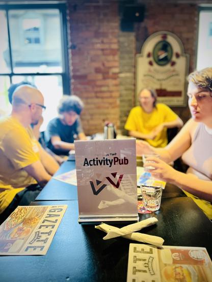 One of the tables at the event with the ActivityPub sign One of the tables at the event with the ActivityPub sign