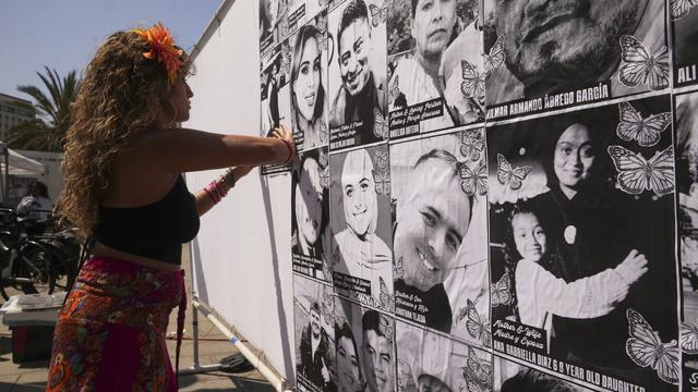 Special needs teacher Deja Nebula sets up an art installation displaying names and faces of people who have been detained, deported, or sent to offshore camps during ICE raids in Southern California, at Olvera Street Plaza in Los Angeles, on Thursday, July 3, 2025. (AP Photo/Damian Dovarganes) Special needs teacher Deja Nebula sets up an art installation displaying names and faces of people who have been detained, deported, or sent to offshore camps during ICE raids in Southern California, at Olvera Street Plaza in Los Angeles, on Thursday, July 3, 2025. (AP Photo/Damian Dovarganes)
