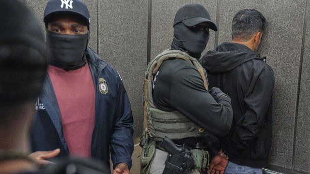 Immigration and Customs Enforcement agents escort a detained immigrant into an elevator after he exited an immigration courtroom, Tuesday, June 17, 2025, in New York. (AP Photo/Olga Fedorova, file)
