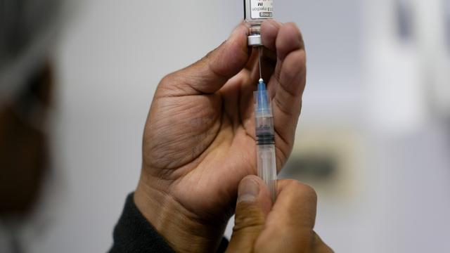 A healthcare worker prepares a shot of the Pfizer COVID-19 vaccine in La Paz, Bolivia, Jan. 7, 2025. (AP Photo/Juan Karita, File)