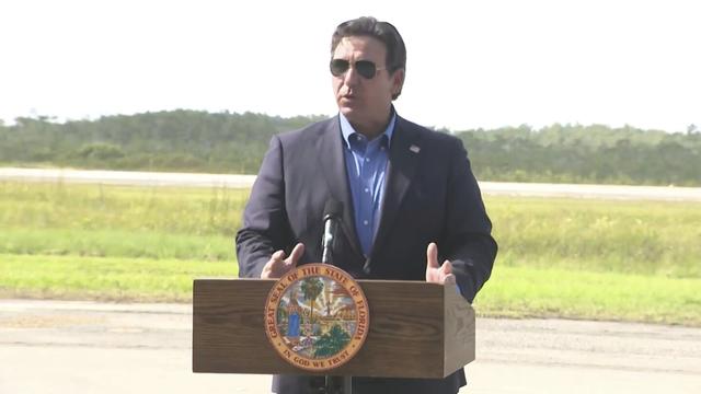 This image from a video feed shows Gov. Ron DeSantis speaking about deportation flights from the remote Everglades immigration lockup known as ”Alligator Alcatraz″ on July 25, 2025 in Ochopee, Florida. (AP Photo via Office Of Florida Governor Ron Desantis)