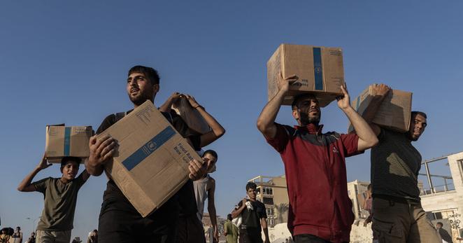 Palestinians with food handouts northwest of Gaza City last month.