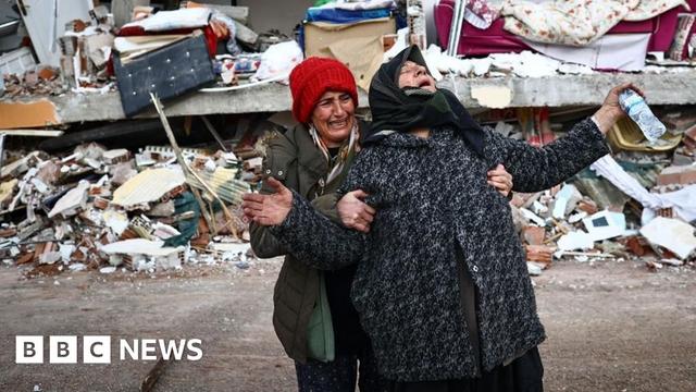 Women react at the site of a collapsed building in the aftermath of a major earthquake in the Elbistan district of Kahramanmaras in Turkey