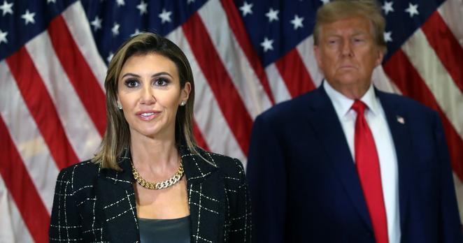 Donald Trump stands with his lawyer Alina Habba as she speaks to the media at one of his properties, 40 Wall Street, following closing arguments at his civil fraud trial on January 11, 2024 in New York City.
